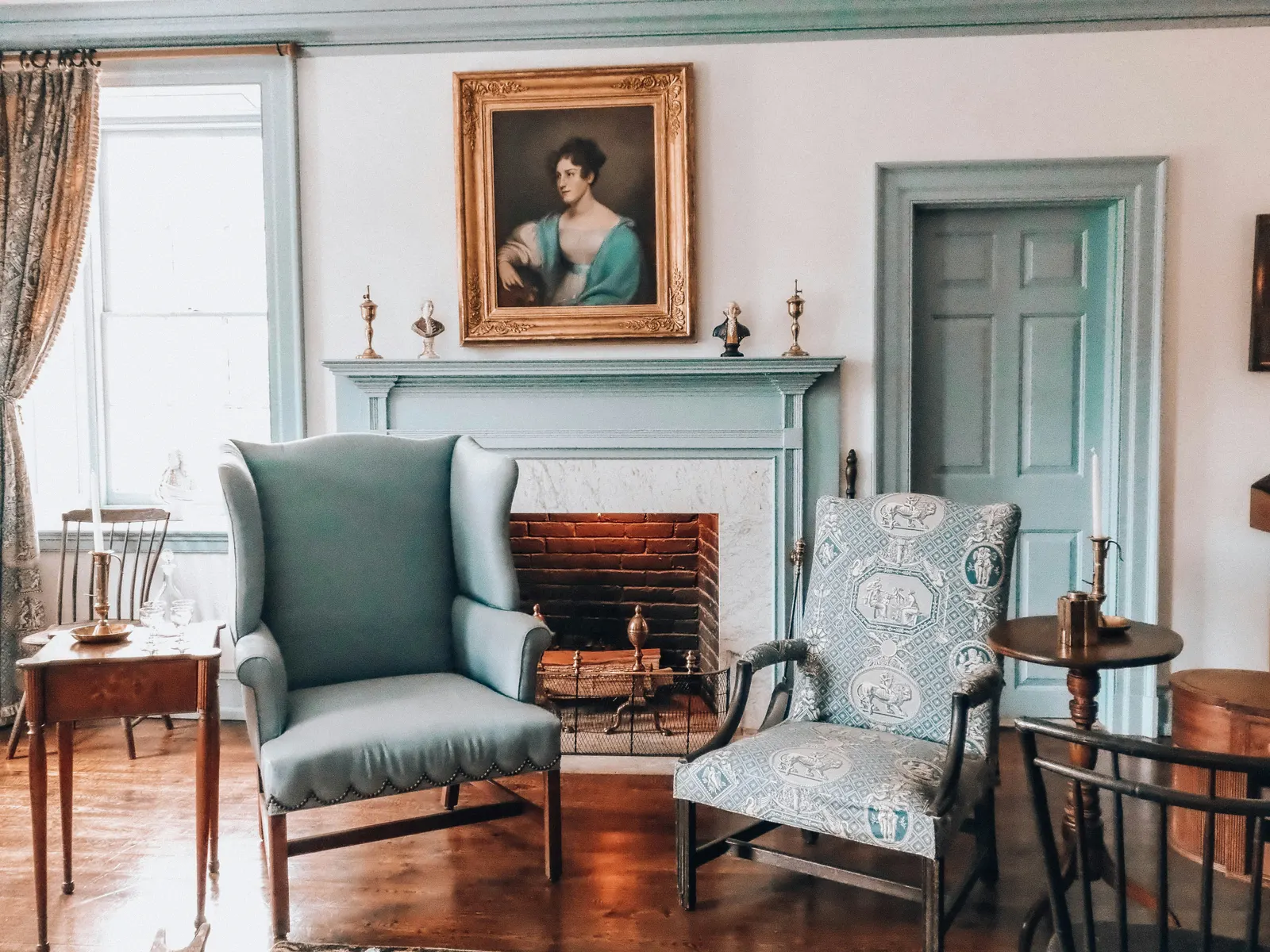Armchairs beside a fireplace in a traditional drawing room